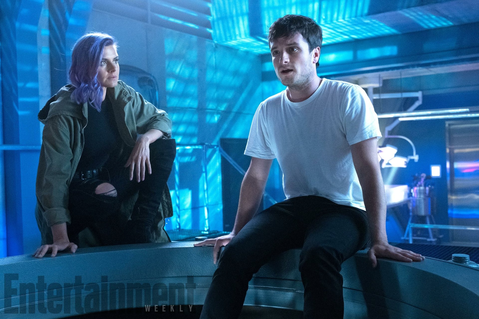 A dynamic scene from the TV show *Future Man*, featuring two characters in a futuristic setting with vibrant blue lighting, creating an engaging HD desktop wallpaper.