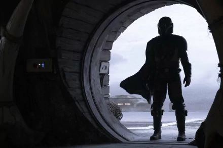 HD PC desktop wallpaper featuring The Mandalorian character from the Star Wars TV show, standing silhouetted at the entrance of a circular doorway.