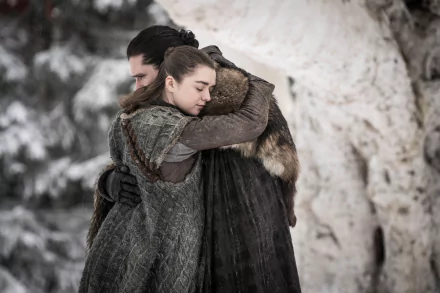 HD PC desktop wallpaper featuring Kit Harington as Jon Snow and Maisie Williams as Arya Stark from the TV show Game of Thrones sharing a heartfelt embrace.