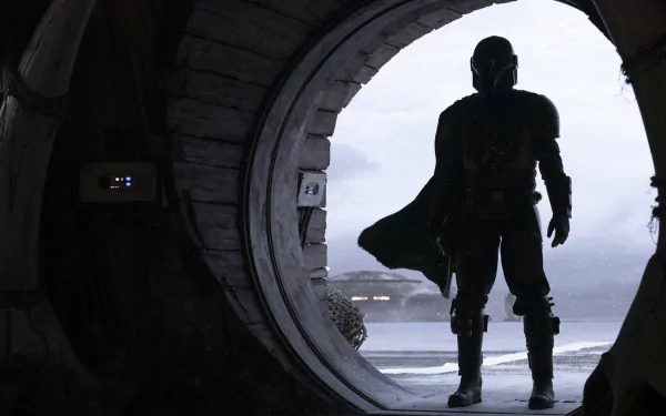 HD PC desktop wallpaper featuring The Mandalorian character from the Star Wars TV show, standing silhouetted at the entrance of a circular doorway.