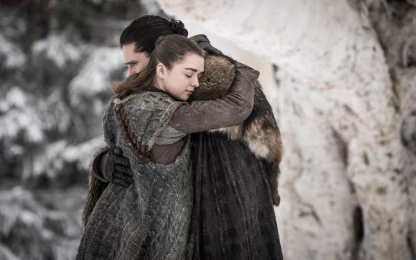 HD PC desktop wallpaper featuring Kit Harington as Jon Snow and Maisie Williams as Arya Stark from the TV show Game of Thrones sharing a heartfelt embrace.