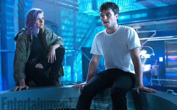 A dynamic scene from the TV show *Future Man*, featuring two characters in a futuristic setting with vibrant blue lighting, creating an engaging HD desktop wallpaper.