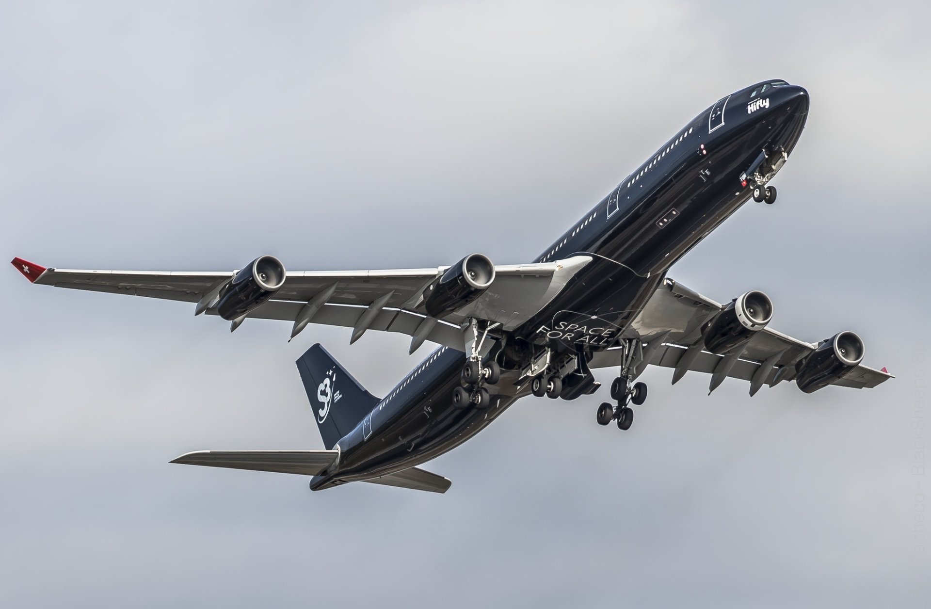 Airbus A340 airplane vehicle in black livery, descending with landing gear down against a gray sky — HD PC desktop wallpaper and background.