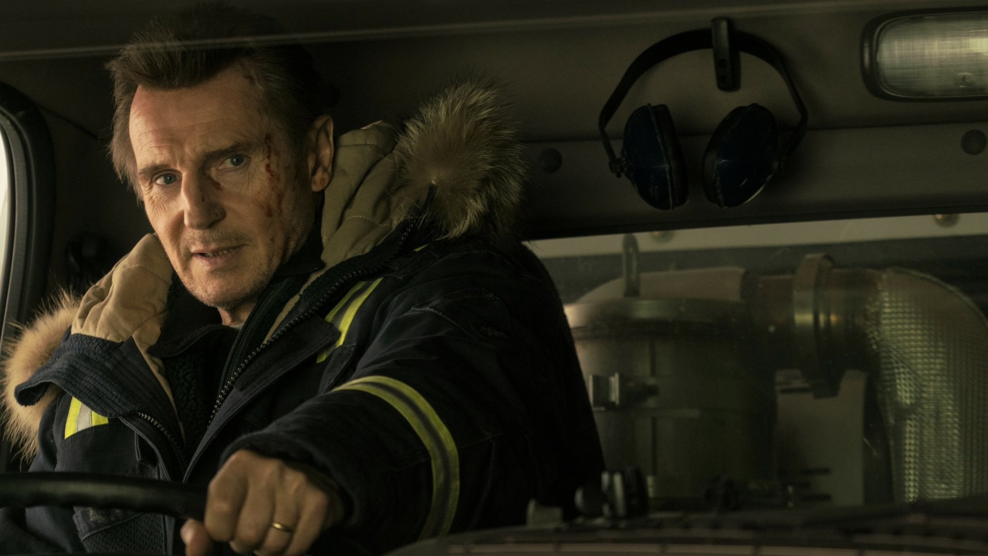 Liam Neeson in character, driving in a scene from Cold Pursuit, captured in a crisp HD desktop wallpaper.