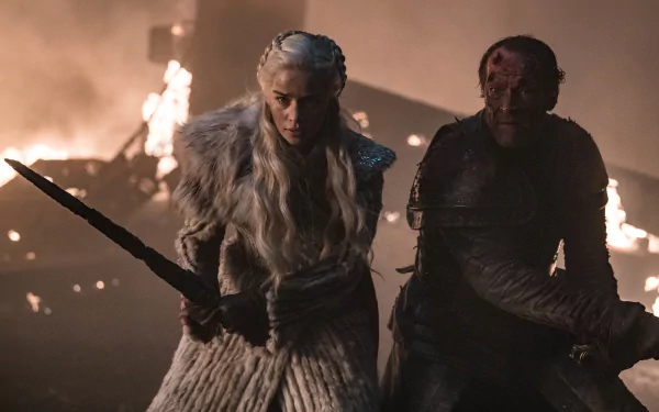 HD desktop wallpaper featuring Emilia Clarke as Daenerys Targaryen and Iain Glen as Jorah Mormont from the TV show Game of Thrones in a fiery battle scene.