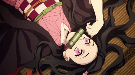 HD desktop wallpaper featuring Nezuko Kamado from Anime 'Demon Slayer: Kimetsu no Yaiba', lying down with a bamboo muzzle.