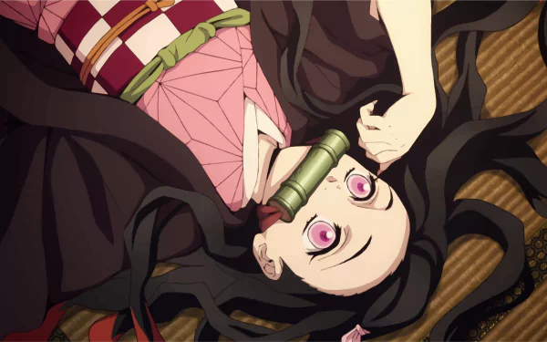 HD desktop wallpaper featuring Nezuko Kamado from Anime 'Demon Slayer: Kimetsu no Yaiba', lying down with a bamboo muzzle.