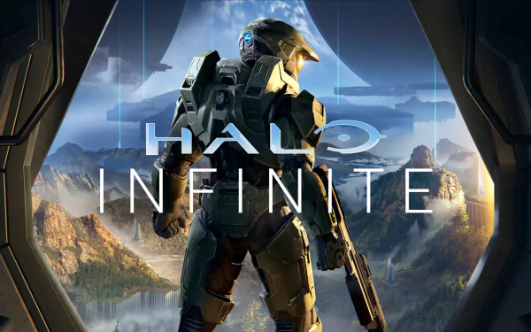HD wallpaper of Halo Infinite featuring the central character in armor, poised in front of a scenic mountainous backdrop, framed by a spaceship doorway.