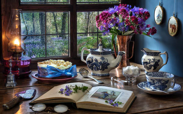 A 4K Ultra HD still life desktop wallpaper featuring a kerosene lamp, blue and white teapot and cup, a book with flowers, and a copper vase of purple blooms by a window.