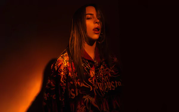 American singer Billie Eilish illuminated by warm, dramatic lighting in a vibrant 4K Ultra HD PC desktop wallpaper and background.