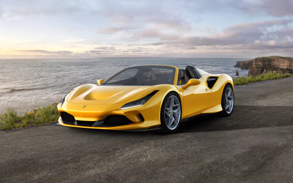 Yellow Ferrari F8 Spider convertible supercar parked on a coastal road at sunset, captured in 4K Ultra HD for PC desktop wallpaper and background.