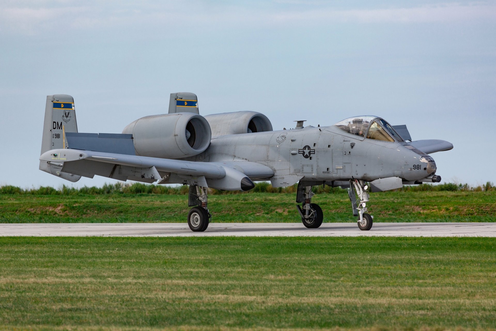 Fairchild Republic A-10 Thunderbolt II warplane, a military jet fighter, parked on a runway with a clear sky and grassy background in 4K Ultra HD quality.