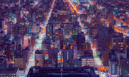 A vibrant 4K Ultra HD man-made cityscape of Sapporo at night, showcasing densely packed illuminated buildings and streets from an elevated perspective.