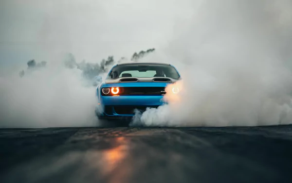 Blue Dodge Challenger SRT Hellcat muscle car performing a burnout, captured in 4K Ultra HD as a dynamic PC desktop wallpaper and background.
