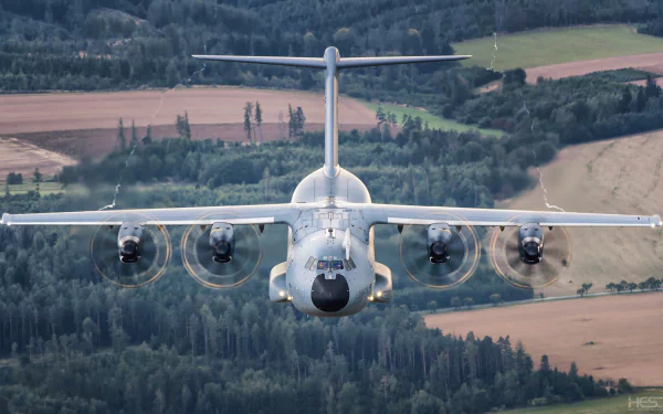 Front view of a military Airbus A400M transport aircraft flying over a rural landscape, captured in high definition as a PC desktop wallpaper.
