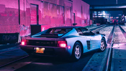 Rear three-quarter view of a silver Ferrari Testarossa parked on rail tracks in a neon magenta-lit industrial alley at night — 2K Quad HD PC desktop wallpaper.