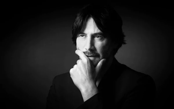 Black-and-white 5K Ultra HD desktop portrait of a contemplative man in a suit, hand to chin, set against a dark backdrop.