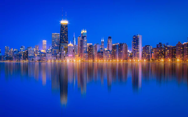 Chicago, USA night skyline along Lake Michigan with illuminated skyscrapers reflected on calm water — 4K Ultra HD PC desktop wallpaper background.