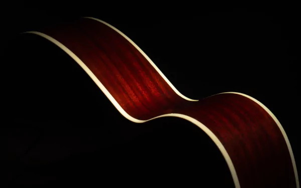 Close-up of a glossy acoustic guitar's curved mahogany body against deep black — 4K Ultra HD PC desktop wallpaper and background conveying music mood.