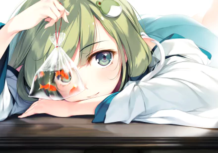 Anime character with green hair and aqua eyes, Sanae Kochiya from Touhou, lying down and holding a small bag with two goldfish. This HD desktop wallpaper is vibrant and detailed.