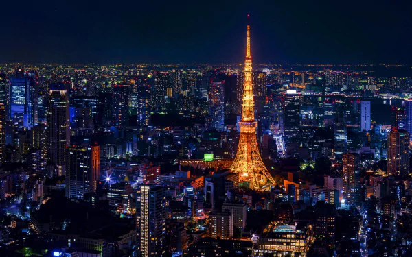 Nighttime Tokyo skyline with illuminated Tokyo Tower rising above city lights — HD PC desktop wallpaper/background of Japan's man-made urban landscape.
