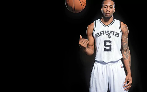 HD wallpaper of Kawhi Leonard in a Spurs jersey spinning a basketball on his finger against a dark background.