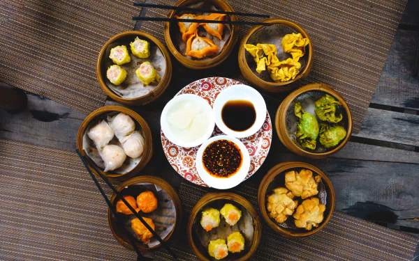  Vibrant shot of feasting on Chinese steamed and fried dim sum by Jakub Kapusnak