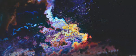 Abstract colorful nebula-like pattern of vivid blues, purples and yellows with starry flecks — 2K Quad HD PC desktop wallpaper and background.