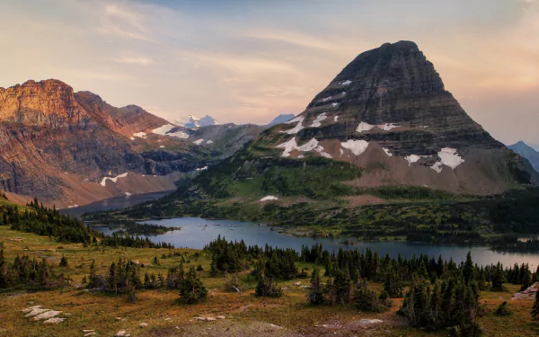 4K Ultra HD PC desktop wallpaper and background: panoramic mountain and river landscape with spruce forests in the foreground and snow-dusted alpine peaks beneath a pastel sky.