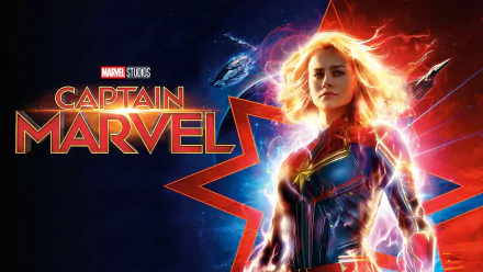 HD PC desktop wallpaper of movie character Carol Danvers (Captain Marvel) in a glowing red-and-blue suit with star emblem, radiant energy and ships against a vibrant cosmic background.
