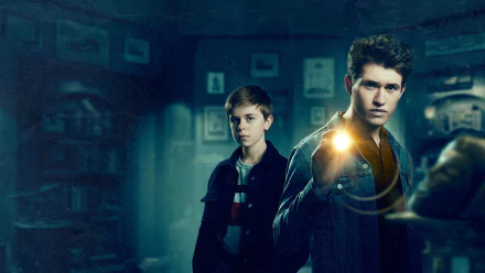 HD desktop wallpaper of The Hardy Boys with one character holding a flashlight in a dim, mysterious room.