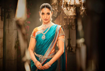 A 4K Ultra HD PC wallpaper featuring celebrity Tamannaah Bhatia in traditional attire, adorned with jewelry, set against a softly lit, elegant background.