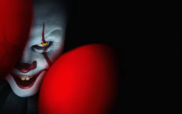 4K Ultra HD PC desktop wallpaper of Pennywise from the movie It Chapter Two, featuring the sinister clown partially hidden behind bright red balloons against a dark background.