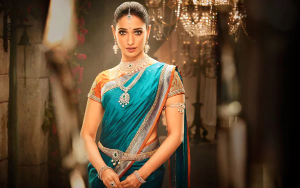 A 4K Ultra HD PC wallpaper featuring celebrity Tamannaah Bhatia in traditional attire, adorned with jewelry, set against a softly lit, elegant background.