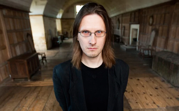 HD desktop wallpaper featuring a person with long hair and glasses in a room with wooden floors and arched ceilings.