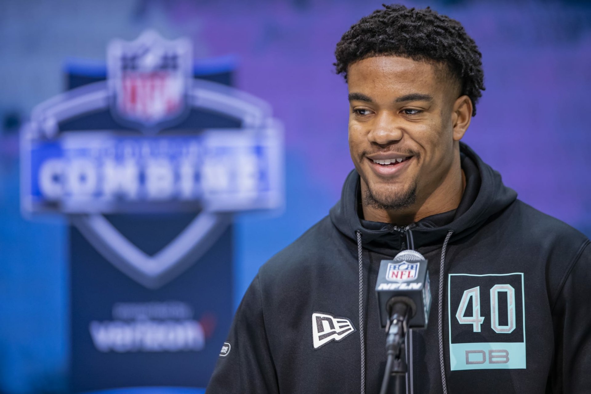 HD desktop wallpaper of Jeremy Chinn smiling at the NFL Combine, wearing a black hoodie with DB 40 printed on it.