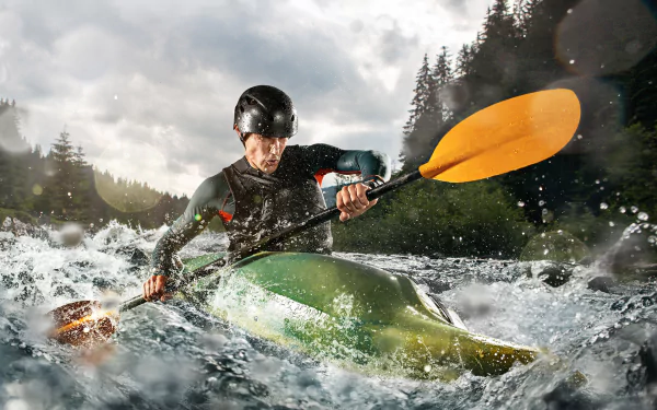 HD wallpaper of a person kayaking through rapids with a forest background.