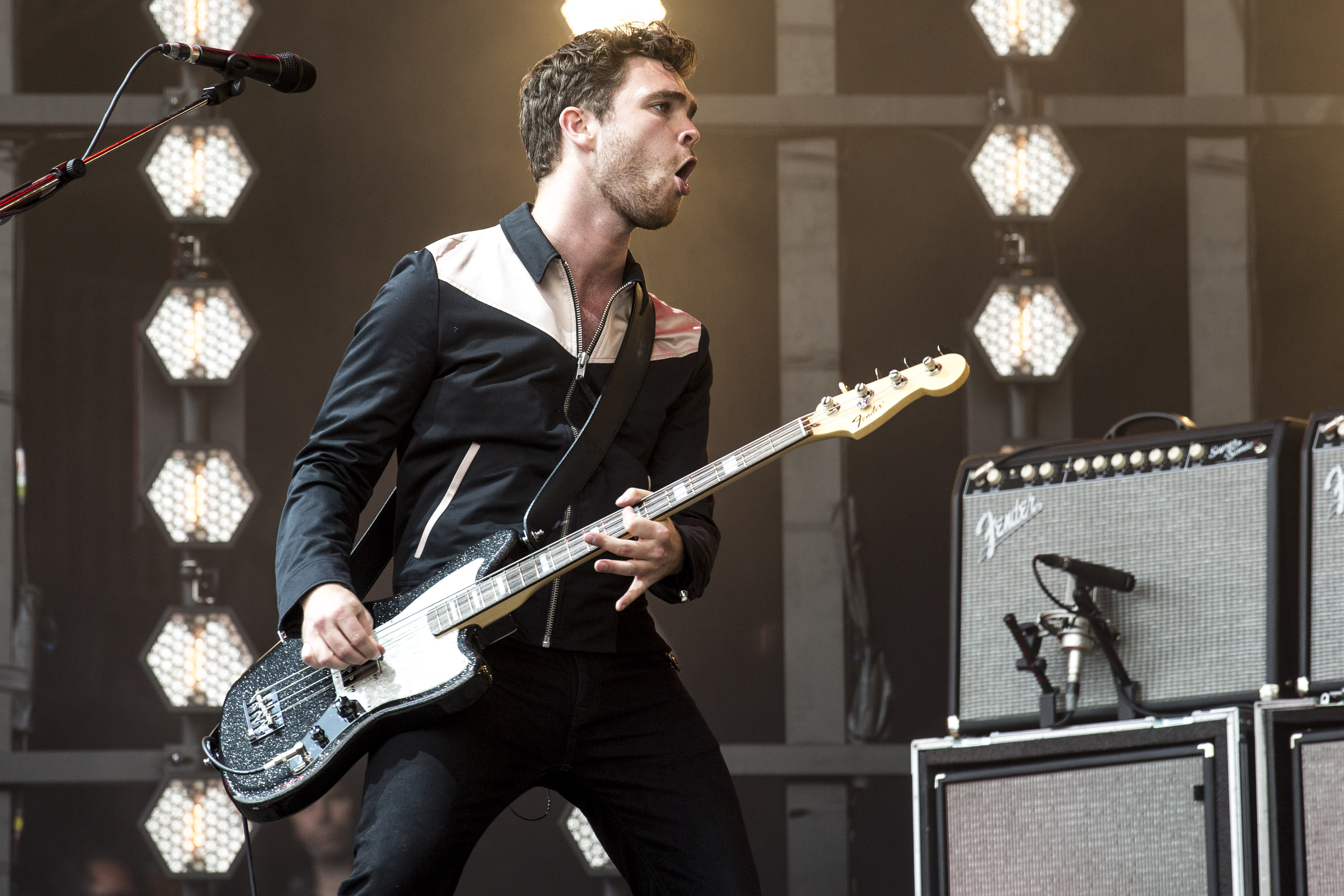 Royal Blood band member performing live with electric guitar in HD concert-themed desktop wallpaper background.