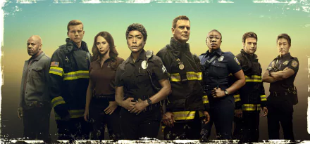 9-1-1 TV show ensemble of firefighters and first responders in uniform posed against a teal sky — 4K Ultra HD PC desktop wallpaper/background.