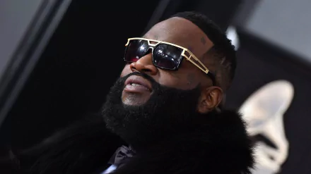 HD wallpaper featuring a close-up of a man with a thick beard, sunglasses, and stylish attire.
