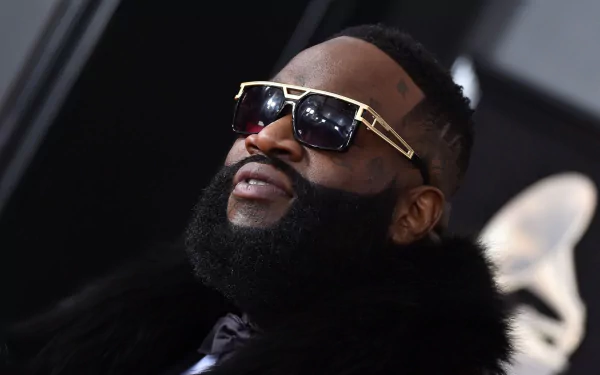 HD wallpaper featuring a close-up of a man with a thick beard, sunglasses, and stylish attire.