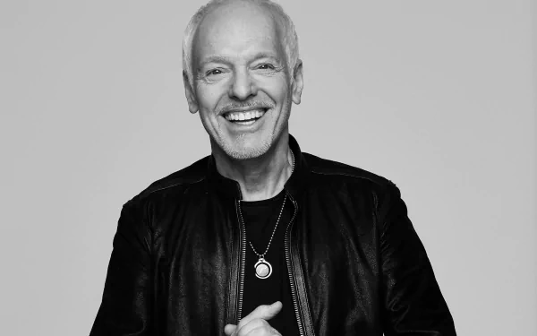 HD desktop wallpaper featuring a monochrome portrait of Peter Frampton smiling, dressed in a black jacket.