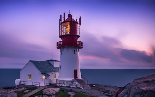 HD PC desktop wallpaper and background: man-made lighthouse on Norway's rocky coast at dusk, red lantern tower with adjoining keeper's house beneath a pastel sky.