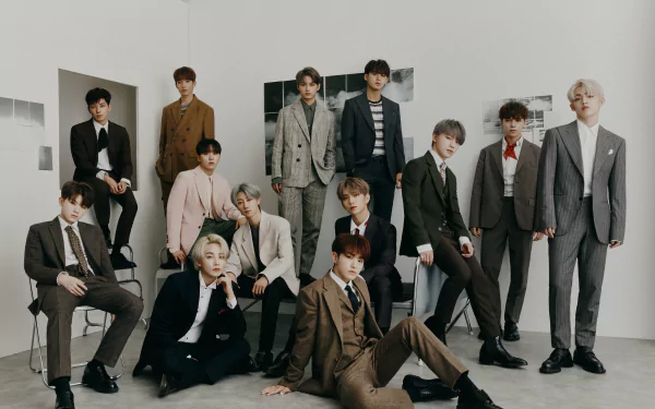 HD desktop wallpaper featuring the 13 members of Seventeen, stylishly dressed in suits, posing together in a sophisticated setting, showcasing their charismatic presence.