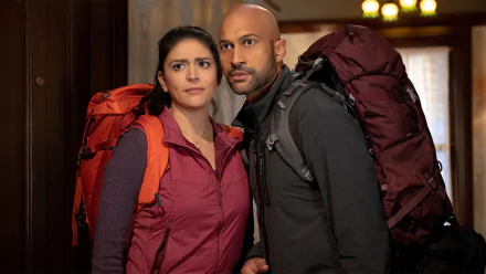 Two hikers with backpacks from Schmigadoon! series featured in a HD desktop wallpaper background.