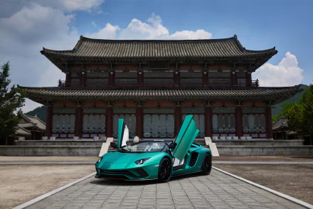 Teal Lamborghini Aventador S supercar vehicle with scissor doors parked on a plaza before a traditional East Asian palace — 5K Ultra HD PC desktop wallpaper
