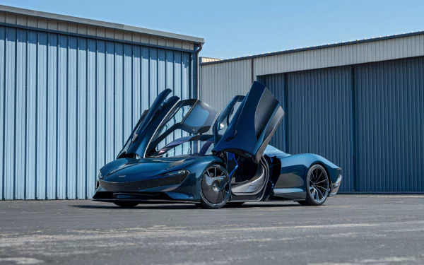 Sleek McLaren Speedtail supercar with butterfly doors open against hangar backdrop — 4K Ultra HD PC desktop wallpaper and background.