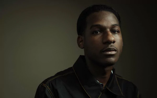 A striking HD desktop wallpaper featuring Leon Bridges, capturing the essence of music with his focused expression against a muted background.