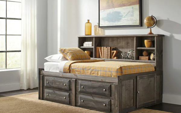 A cozy, wooden bed with storage drawers and a headboard filled with books and decor, set against a bright, airy room with large windows. HD desktop wallpaper.
