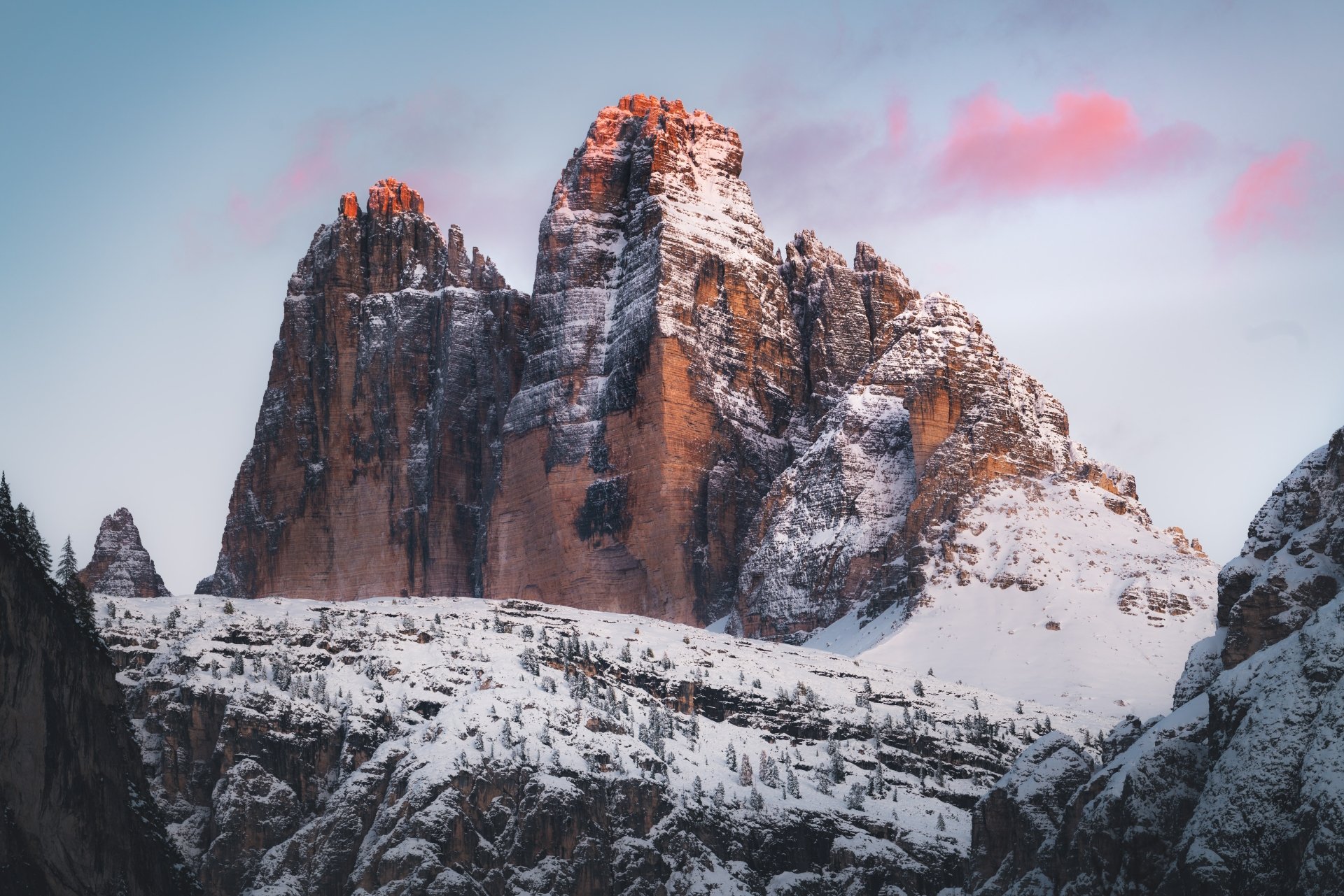 Snow-capped Tre Cime di Lavaredo mountain peaks bathed in soft light, captured in stunning 8K Ultra HD as a nature desktop wallpaper background.